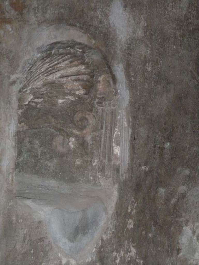 Ins. Orientalis II.9, Herculaneum. September 2015. Niche in north wall. According to Deiss – a niche stuccoed as a seashell, sheltered a statuette (now missing) of one of the gods. Above and around the shrine was a fine fresco (now barely visible) of a robed Hercules pouring a libation between a nude Dionysus and a nude Mercury, who amongst other things, was the patron god of shop keepers. The fresco must have been the pride of the shop.
See Deiss, J.J. 1968. Herculaneum: a city returns to the sun. UK, The History Book Club, (p.104-6).